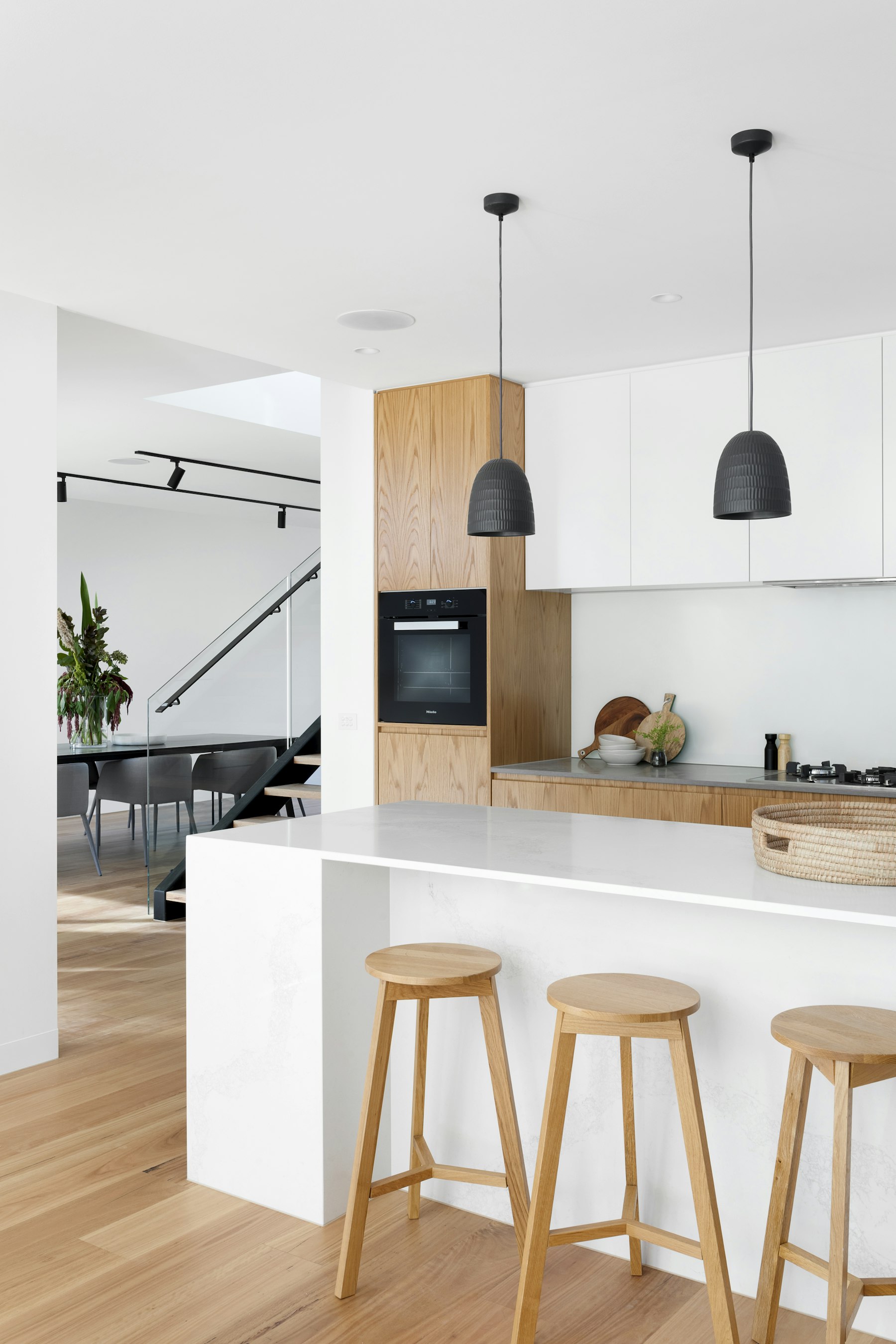 Wood kitchen with black pendant lighting